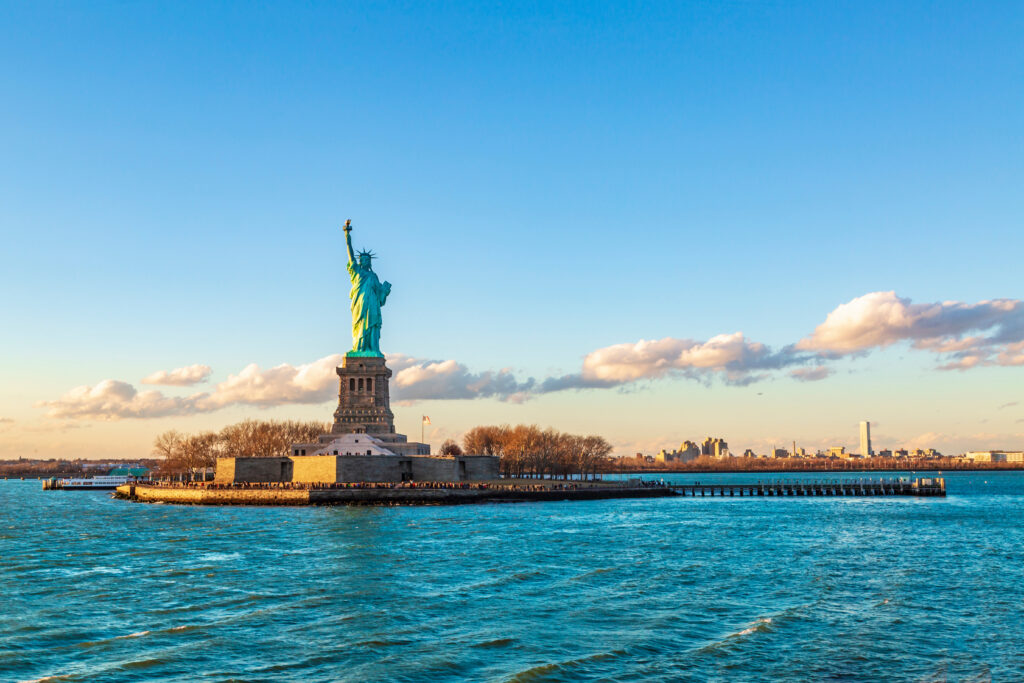 Statue of liberty horizontal during sunset in New York City, NY, USA